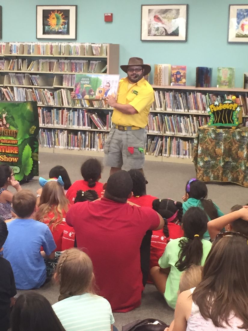 Author Jimmy Vee reading his book to a crowd of kids at a library
